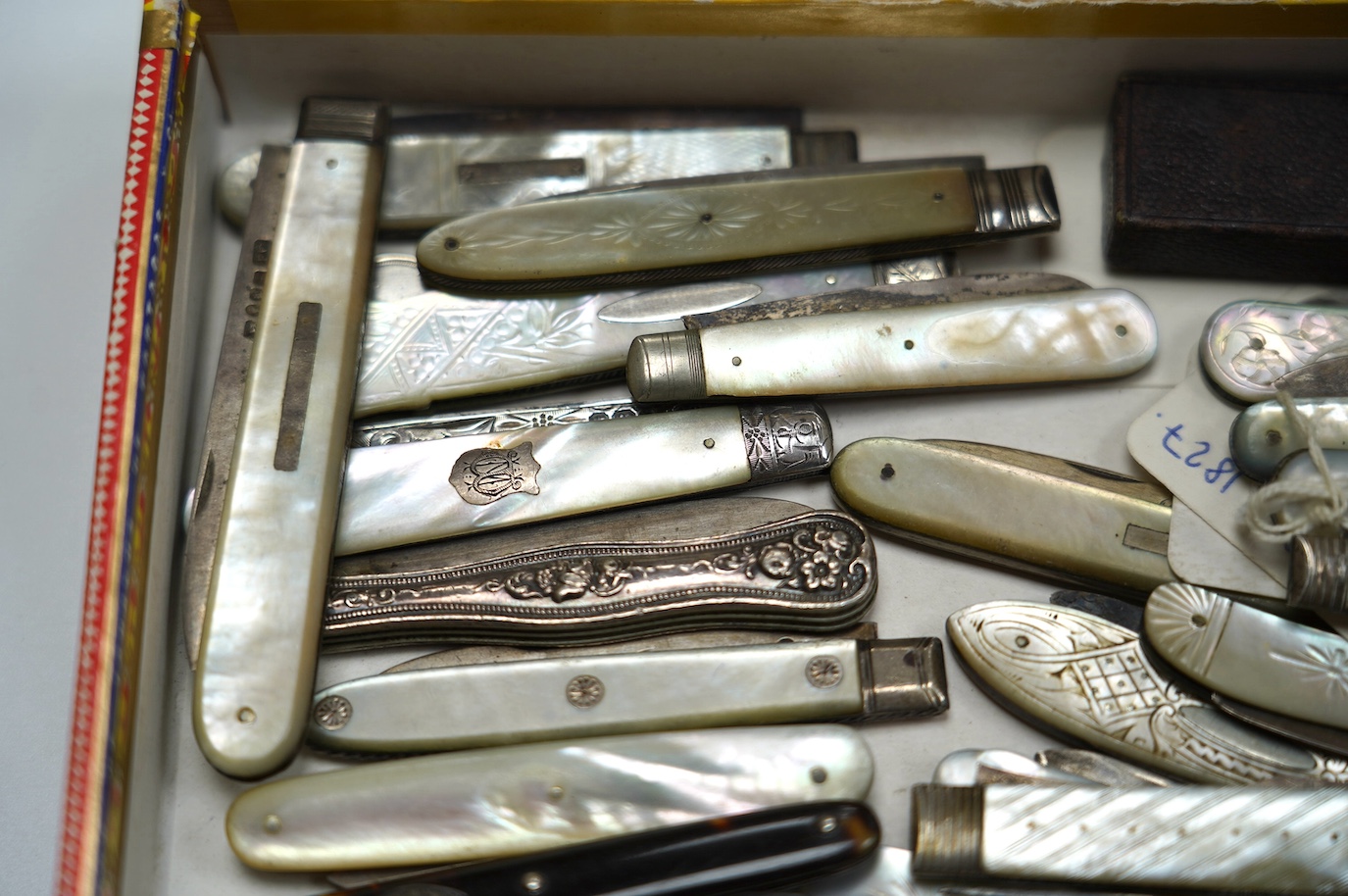 A collection of twenty two assorted mainly Victorian mother of handled silver fruit knives, one with leather case, together with a similar sterling knife and four Georgian silver travelling forks, three with mother of pe